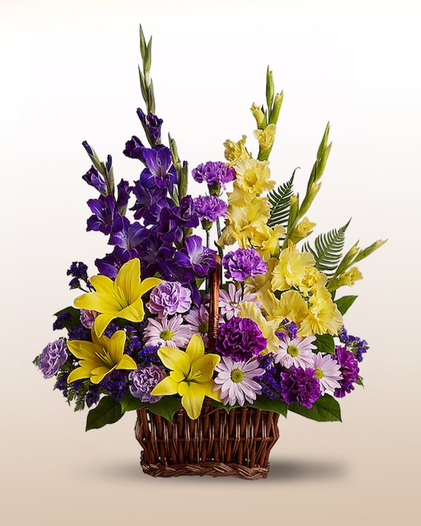 Memorial flower basket with yellow lilies and purple blooms. A warm and meaningful tribute delivered across the USA.