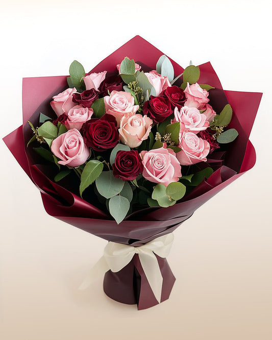 A refined bouquet of 18 pink and red roses arranged in a modern, balanced style. An elegant romantic gift delivered worldwide by trusted local florists.