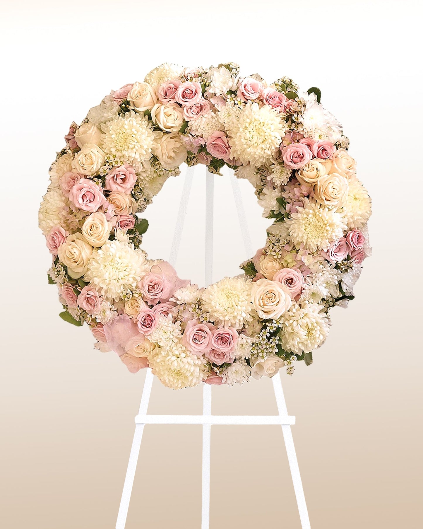 Elegant ivory and blush funeral wreath with roses and chrysanthemums. A soft, heartfelt farewell delivered across the USA.
