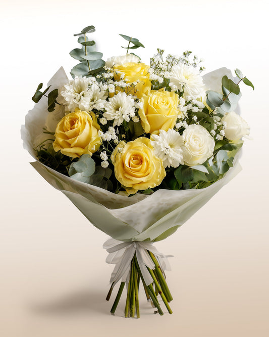 A serene bouquet of yellow roses and soft white flowers. Elegant, fresh, and handcrafted.