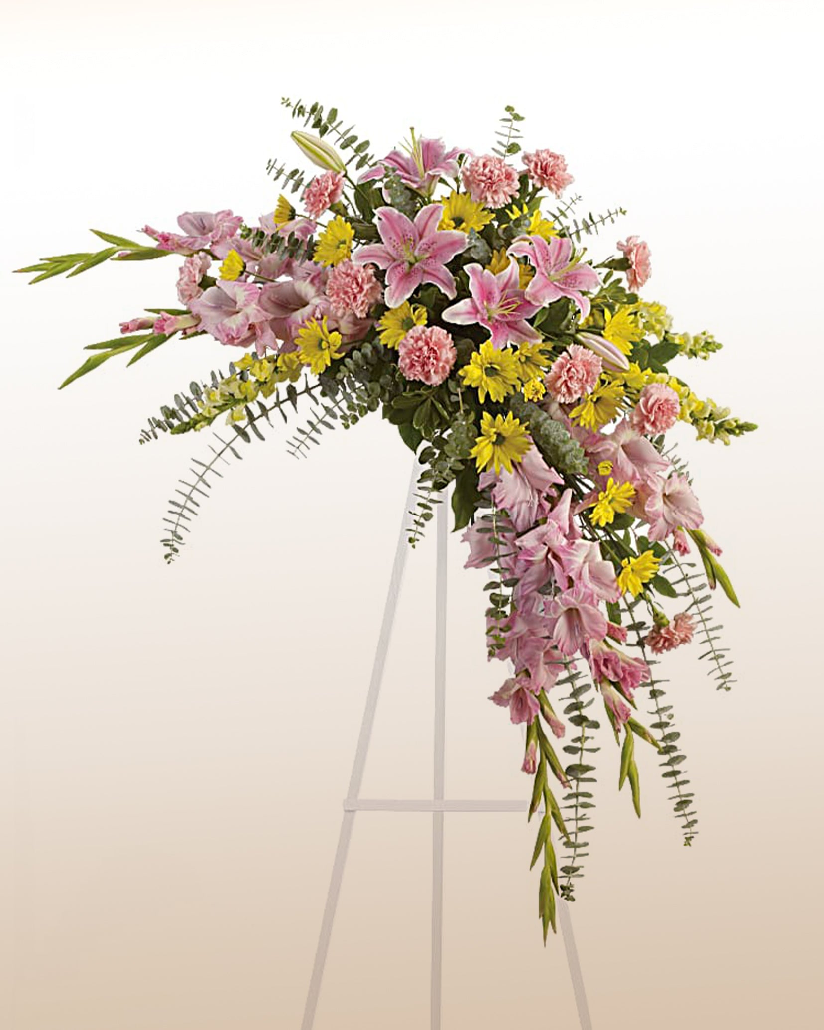 Memorial flower arrangement with lilies, carnations, and yellow blooms. A graceful tribute delivered across the USA.