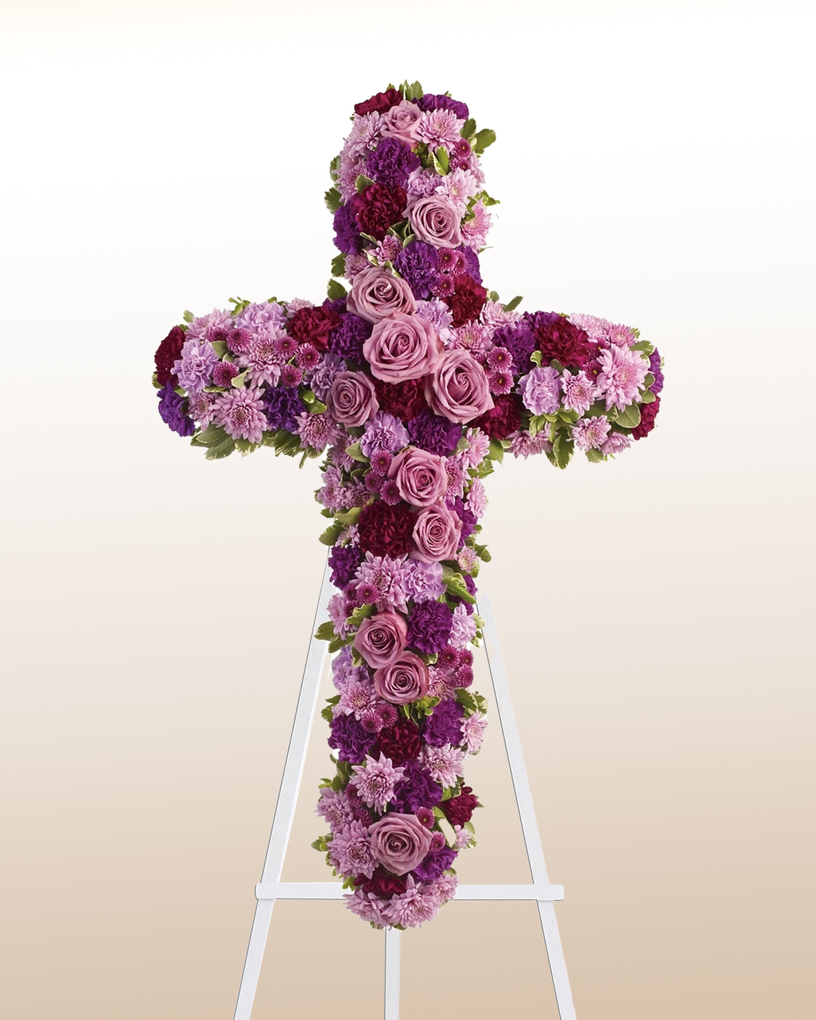 Elegant funeral cross with lavender roses and purple blooms. A serene tribute delivered with care across the USA.