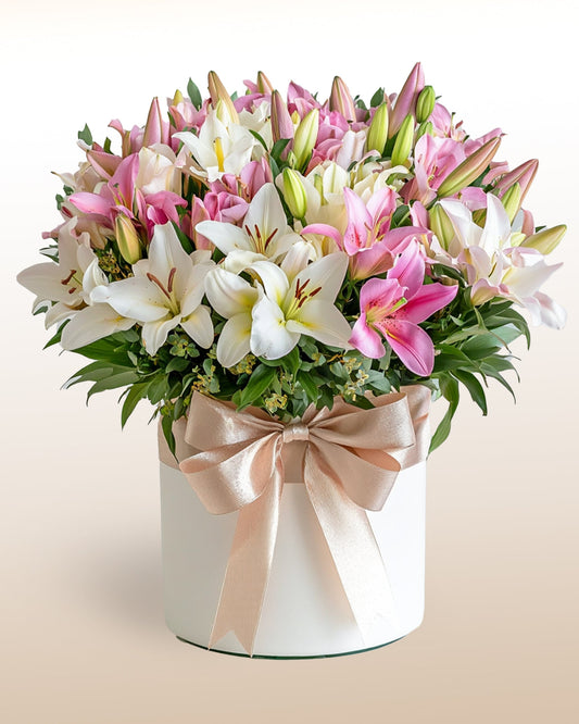 A refined luxury arrangement of 36 lilies. Pure, elegant, and timeless.