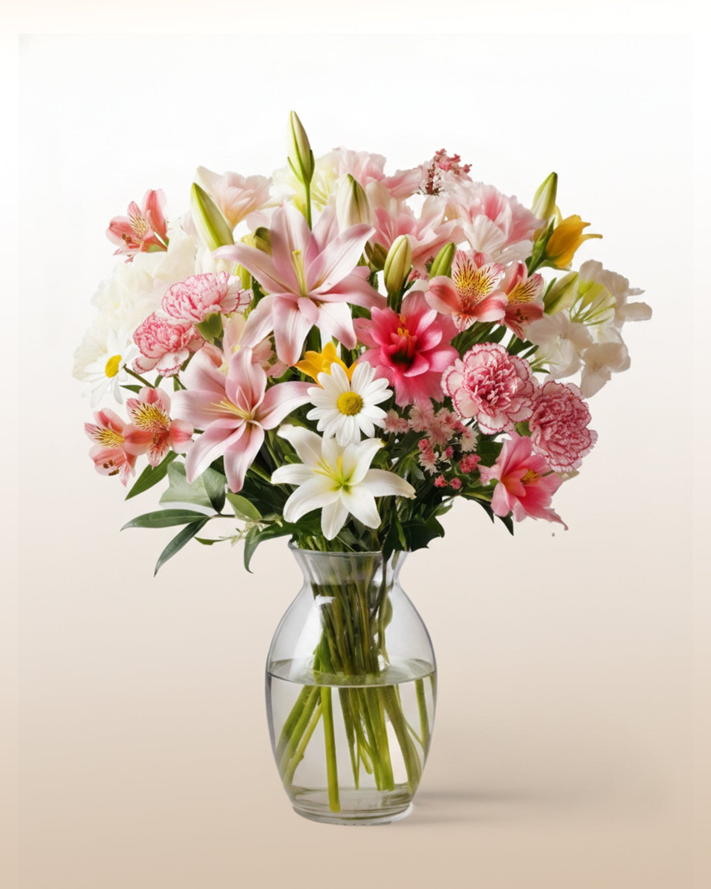A soft blend of seasonal lilies, carnations and peruvian lilies arranged in a fresh, balanced style. Warm, bright, and comforting, this bouquet brings a gentle touch to celebrations, support, or thoughtful everyday gestures. Notes: Images are illustrative. Flower varieties, tones, and wrapping may vary based on season and the local florist. Quality and overall design are always maintained.