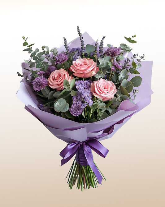 A soft and elegant bouquet of pink roses and seasonal florals. Simple, heartfelt, and beautifully refined.