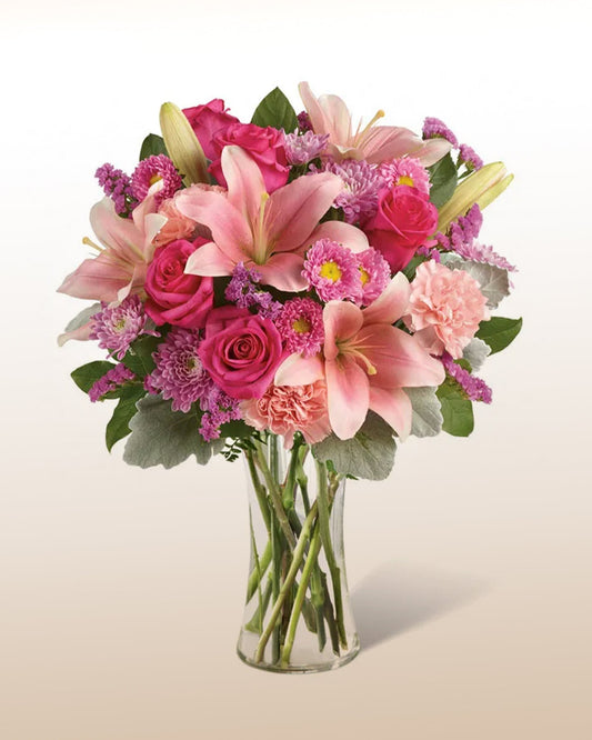 A refined pink floral bouquet with lilies and roses. Balanced, graceful, and handcrafted.