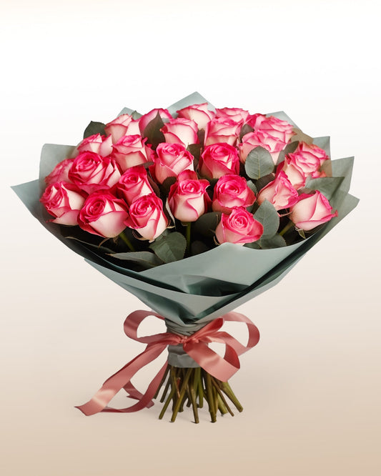 An elegant bouquet of 24 bi-colored roses with soft ivory and pink tones. Classic, refined, and handcrafted.