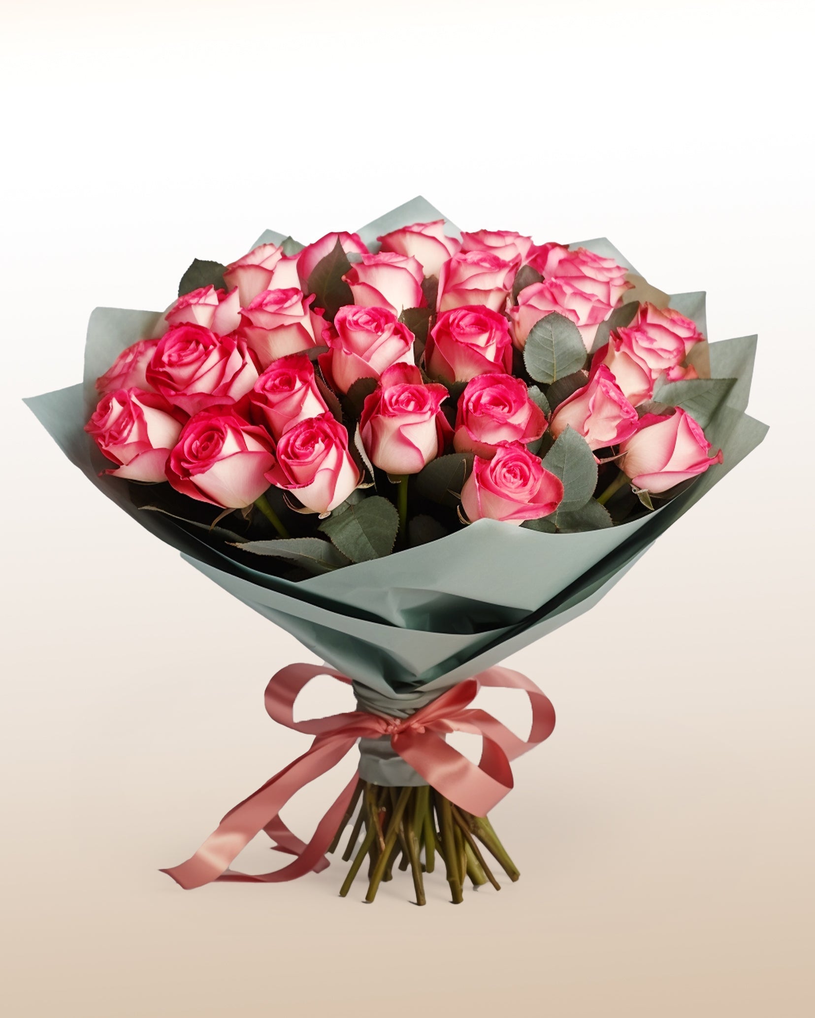 An elegant bouquet of 24 bi-colored roses with soft ivory and pink tones. Classic, refined, and handcrafted.