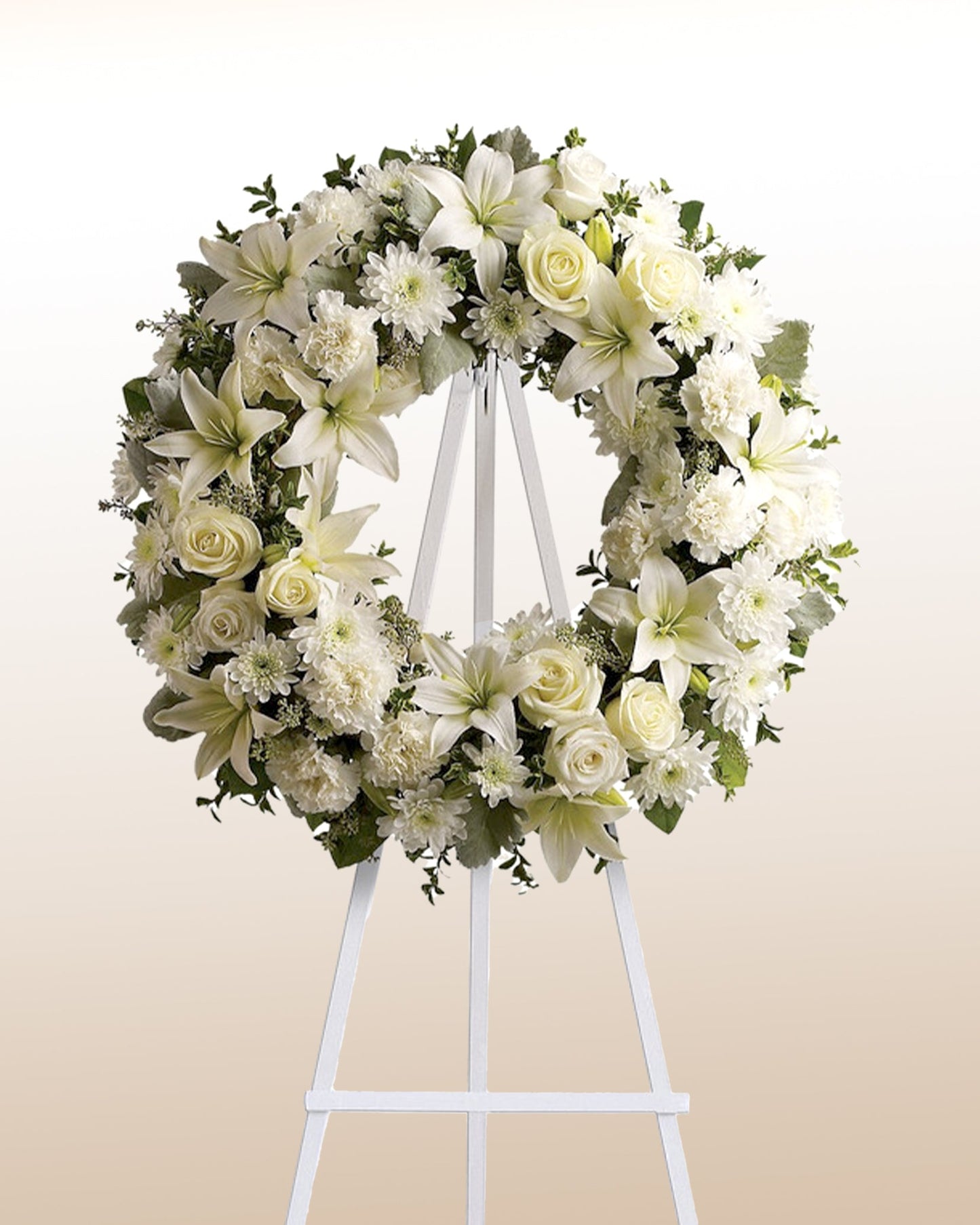 Classic white funeral wreath with lilies, roses, and chrysanthemums. A timeless expression of sympathy delivered across the USA.